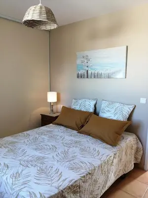 a bedroom with a bed in a room with a lamp at GITE CHEZ JULES ET ODETTE in Comigne