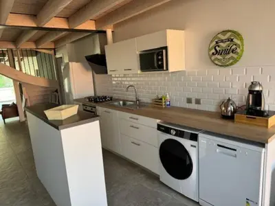 a kitchen with a sink and a dishwasher at domaine en castanet in Caraman
