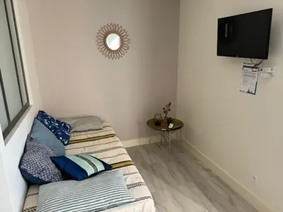 a room with two beds and a television on a wall at domaine en castanet in Caraman