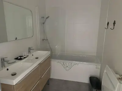 a bathroom with a tub and a sink and a mirror at domaine en castanet in Caraman
