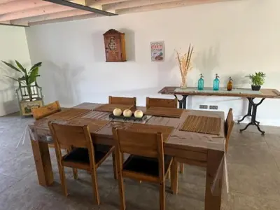 a wooden dining room table with chairs and a tableablish at domaine en castanet in Caraman