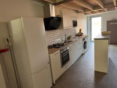 a kitchen with white appliances and a white refrigerator at domaine en castanet in Caraman