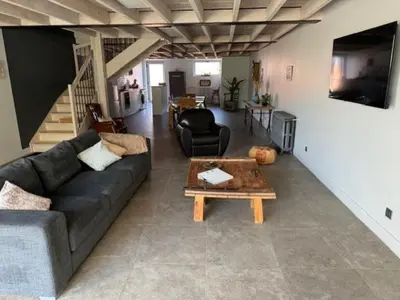 a living room with a couch and a table at domaine en castanet in Caraman