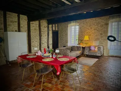 a table with two wine glasses and a bottle of champagne at Le Domaine de Pépé in Saint-Julien-de-Briola