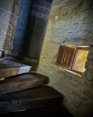 a stone building with stairs and a window at Le Domaine de Pépé in Saint-Julien-de-Briola