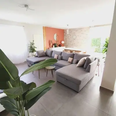 a living room with a couch and a table at Villa 