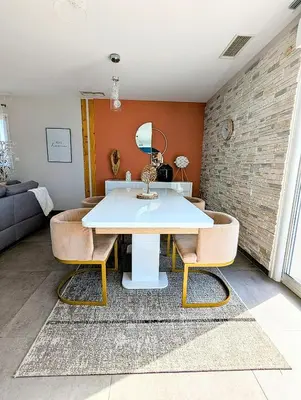 a dining room with a white table and chairs at Villa 