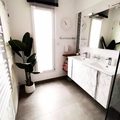 a bathroom with a sink and a mirror and a window at Villa 