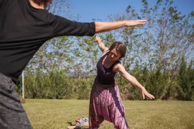 two people playing with a frisbee in a field at Château de la Motte - Entre Narbonne et le Canal du Midi in Marcorignan