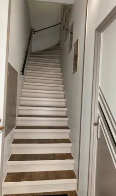 a staircase leading up to a stair case in a building at La tranquillité en centre-ville avec terrasse in Limoux