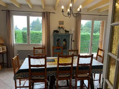 a dining room with a table and chairs and windows at Fantastic Four Bed Family Home in Fontiers-Cabardès