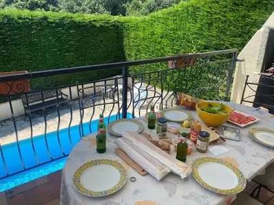 a table with plates of food on a balcony at Fantastic Four Bed Family Home in Fontiers-Cabardès