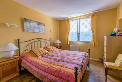 a bedroom with a bed and a chair at Fantastic Four Bed Family Home in Fontiers-Cabardès