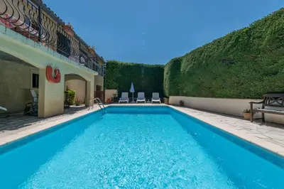 a swimming pool in a yard next to a building at Fantastic Four Bed Family Home in Fontiers-Cabardès