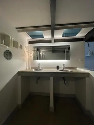 a bathroom with two sinks and a large mirror at La Tuilerie du Bazalac in Trèbes