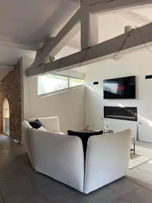 a living room with a couch and a table at La Tuilerie du Bazalac in Trèbes