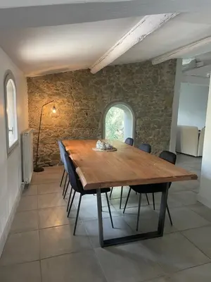a dining room with a wooden table and chairs at La Tuilerie du Bazalac in Trèbes