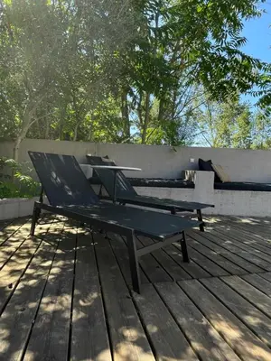 a bench sitting on top of a wooden deck at La Tuilerie du Bazalac in Trèbes