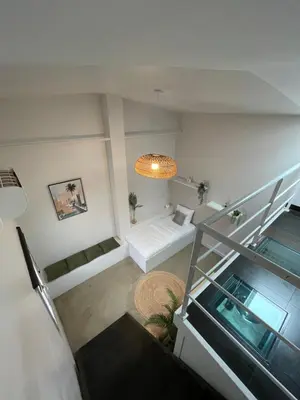 an overhead view of a living room with a staircase at La Tuilerie du Bazalac in Trèbes