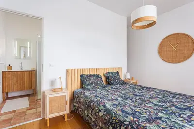 a bedroom with a bed and a mirror at Maison charme et confort - piscine chauffée in Tarabel