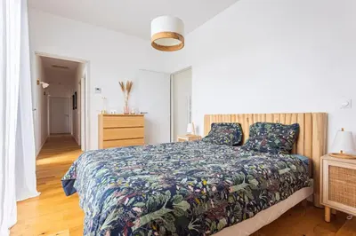 a bedroom with a bed with a colorful bedspread at Maison charme et confort - piscine chauffée in Tarabel