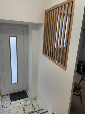 a room with a door and a stairwell with a window at Le Careyrou in Paziols