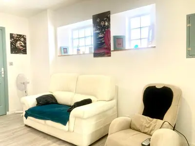 a living room with two chairs and a couch at 