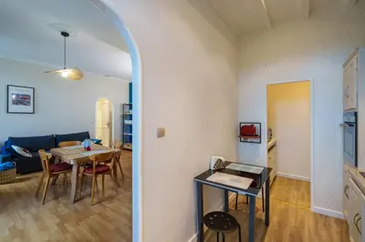 a living room with a table and a dining room at Le petit coin de la bastide 11 in Carcassonne