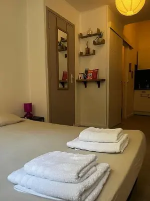 two towels sitting on a bed in a room at Studio Distillerie in Narbonne