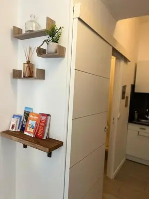 a room with a door and a shelf with books at Studio Distillerie in Narbonne