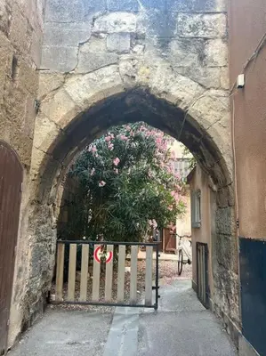 an archway in a stone building with a gate at Studio Distillerie in Narbonne