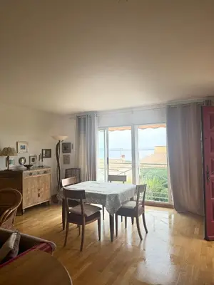 a dining room with a table and chairs and a window at la vue des étangs in Bages