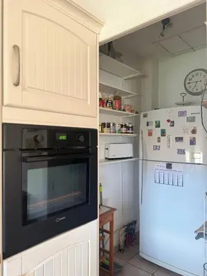 a kitchen with a stove and a refrigerator at la vue des étangs in Bages