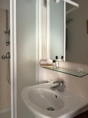 a bathroom with a sink and a mirror at la vue des étangs in Bages