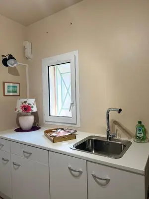 a kitchen counter with a sink and a window at la vue des étangs in Bages
