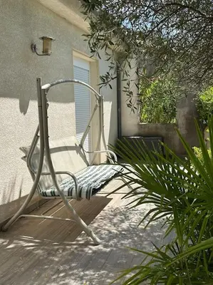a chair sitting in front of a building at Gorgeous 5 bedroom villa with air con, heated pool and garden for 12 in Villemoustaussou