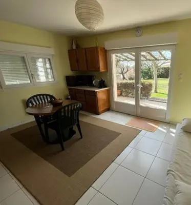 a living room with a table and a kitchen at Gorgeous 5 bedroom villa with air con, heated pool and garden for 12 in Villemoustaussou