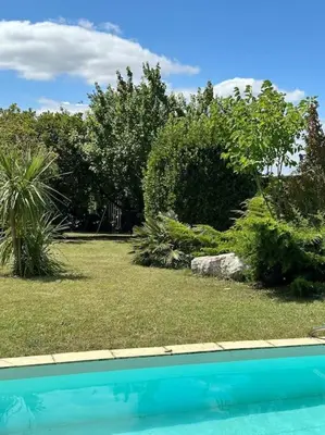 a yard with a swimming pool and trees and bushes at Gorgeous 5 bedroom villa with air con, heated pool and garden for 12 in Villemoustaussou