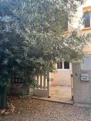 a tree with a door in front of a building at Appart Distillerie in Narbonne