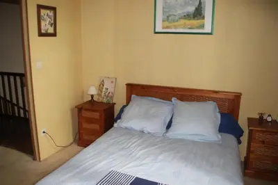 a bedroom with a bed with white sheets and pillows at Chez Didier 1 in Saint-Michel-de-Lanès