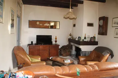a living room with leather furniture and a fireplace at Chez Didier 1 in Saint-Michel-de-Lanès