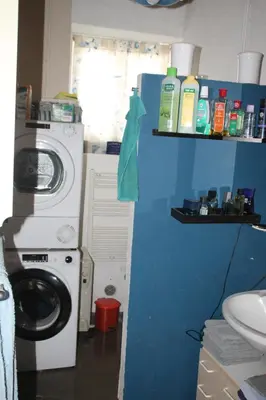 a bathroom with a washing machine and a washer at Chez Didier 1 in Saint-Michel-de-Lanès