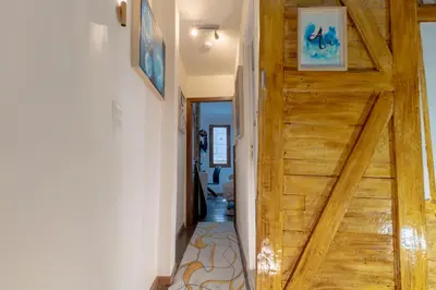 a wooden door leading to a hallway with a hallway at The retreat in Montréal