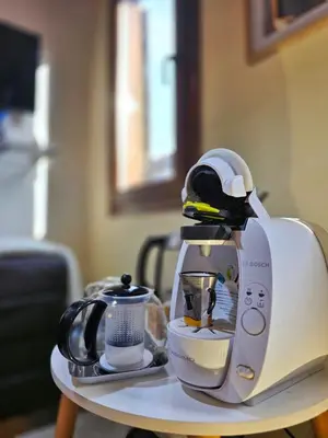 a coffee maker on a table with a tea kettle at The retreat in Montréal