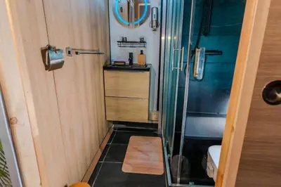 a small bathroom with a shower and a sink at The retreat in Montréal