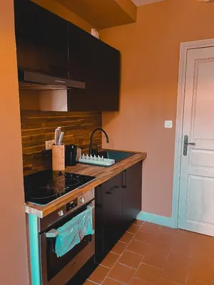a kitchen with a stove and a counter top at La Cité Voltaire in Carcassonne