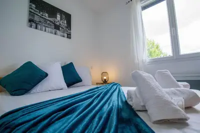 a bedroom with a bed with blue and white pillows at La casa du lac vue imprenable in Homps
