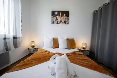a bedroom with a large bed with towels on it at La casa du lac vue imprenable in Homps