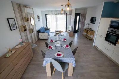 a kitchen and living room with a table with food on it at La casa du lac vue imprenable in Homps