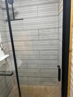 a shower with a closed door in a bathroom at Maison de vacances in Conilhac-Corbières